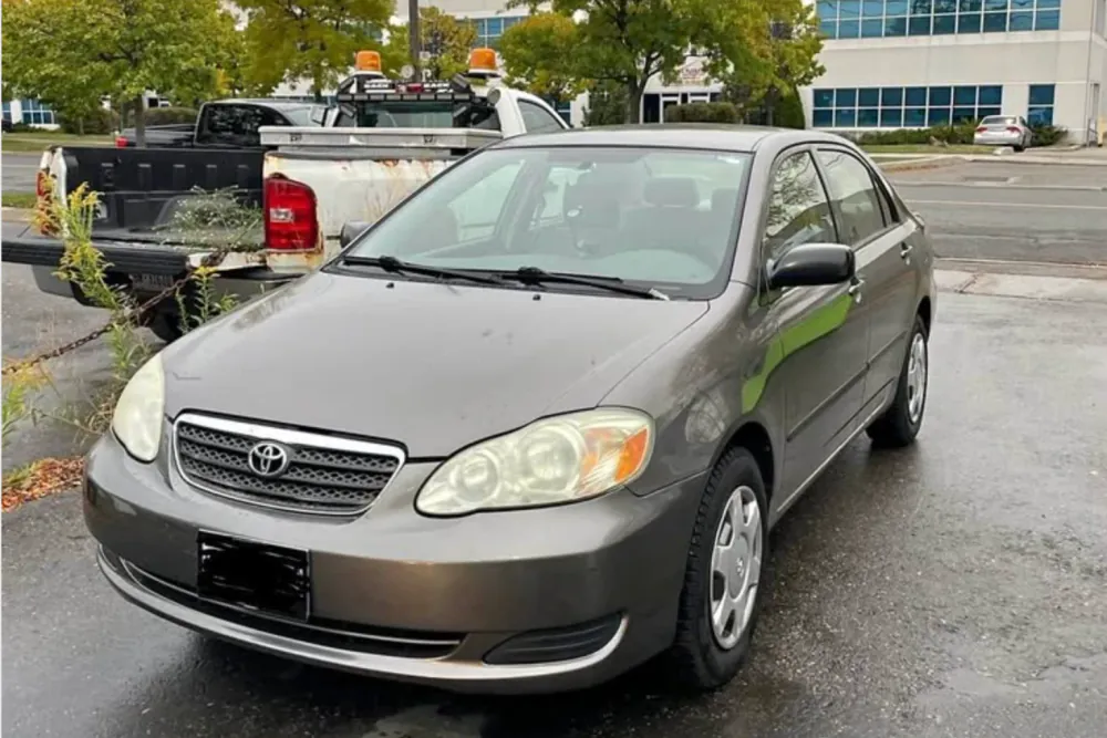 Grey Toyota Corolla sedan parked in a lot in Scarborough